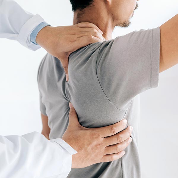Physiotherapist doing healing treatment on man's back