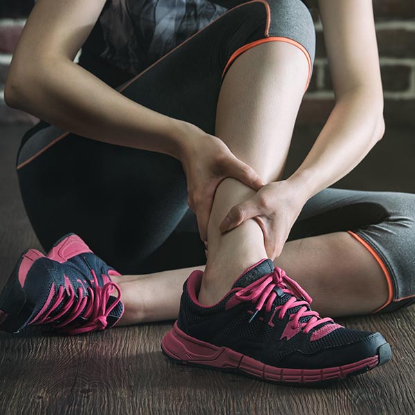 Woman's ankle injured in gym fitness exercise training